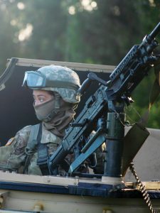 PFC Catherine Urbano, a motor transport operator assigned to Fox Company, 427th Brigade Support Battalion, prepares to leave on a patrol.