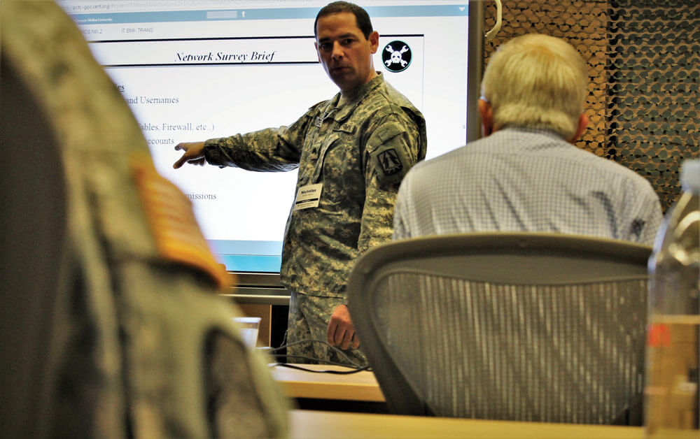 SGT Nicholas Malone of ARCOG, 335th Signal Command (Theater), is evaluated while giving a network survey brief.