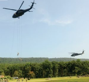 Soldiers training as part of Fort Indiantown Gap's inaugural air assault course rappel from a UH-60 Black Hawk Helicopter.