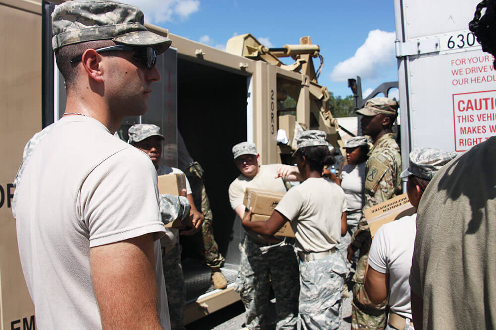 South Carolina National Guard Soldiers assigned to the 1118th Forward Support Company load pods with food and water for transport to south Florida in response to Hurricane Irma.