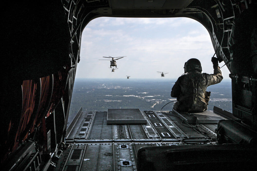 A formation of six South Carolina Army National Guard CH-47F Chinook heavy-lift cargo helicopters assigned to Detachment 1, B Company, 2-238th, General Support Aviation Battalion, 59th Aviation Troop Command, departs for a year-long deployment to Afghanistan.