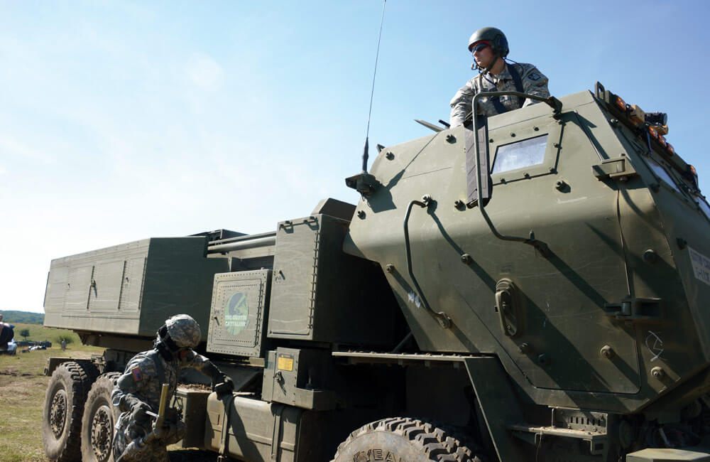 Soldier of the 5th Battalion, 113th Field Artillery Regiment, waits for refueling of a High Mobility Artillery Rocket System.