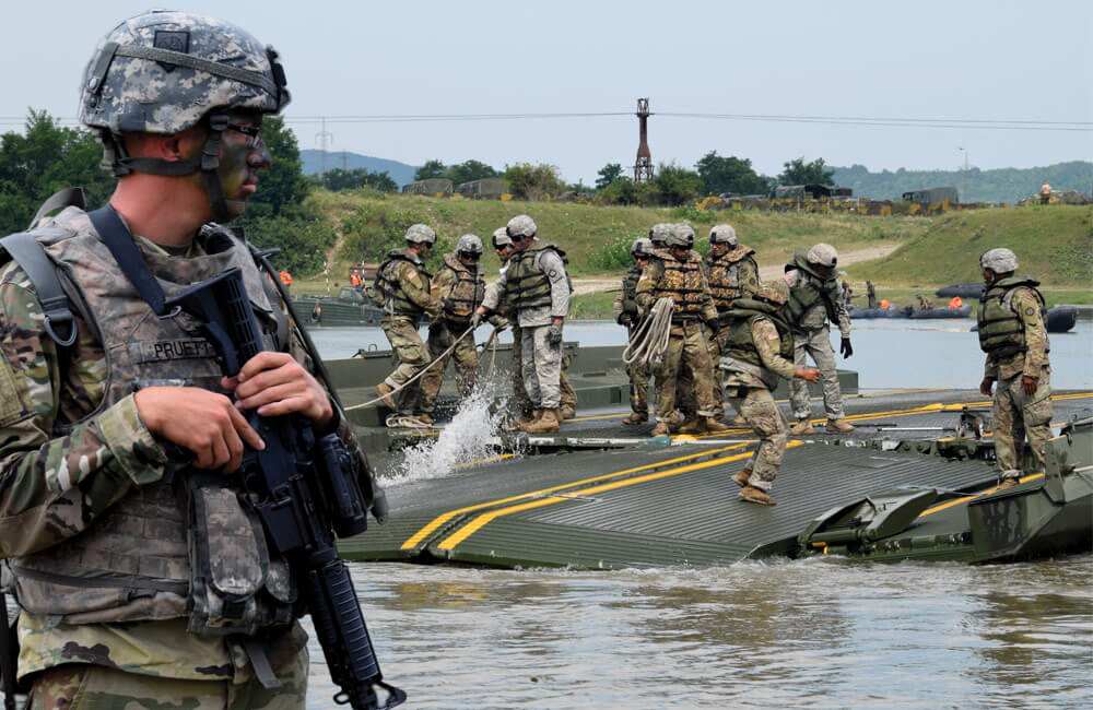 Georgia Army National Guard SPC Joshua Pruett; Soldiers of the Fort Leonard Wood-based 50th Multi-Role Bridge Company move a section of improved ribbon bridge into place.