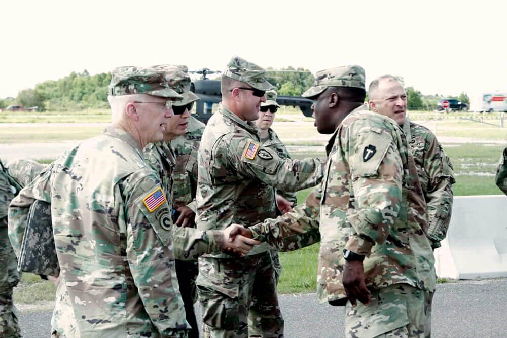 COL Carlton Smith (right) greets senior leaders to the area of operations for Hurricane Harvey relief efforts.