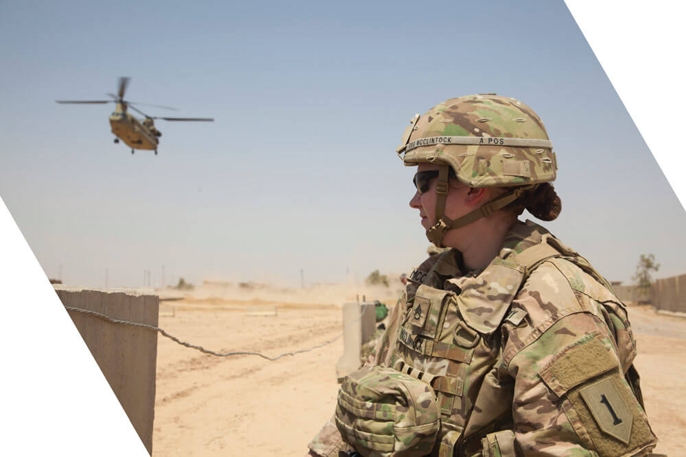 SSG Heidi McClintock of Nebraska’s 1st Infantry Division MCPOD waits for a CH-47 Chinook to land at a tactical assembly area near Mosul, Iraq.