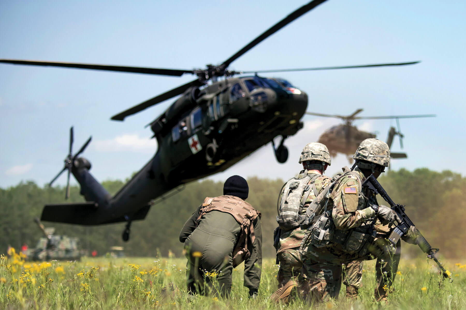 Army National Guard Soldiers await the arrival of a UH-60 Black Hawk medevac helicopter during the South Carolina National Guard Air and Ground Expo at McEntire Joint National Guard Base, S.C.