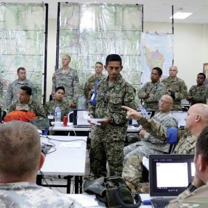 LTC George Hansen, commander of the 1-148th Field Artillery Regiment, works with his counterpart from the Malaysian Army giving production of operation orders during exercise Keris Strike 2017 in Pahang, Malaysia.