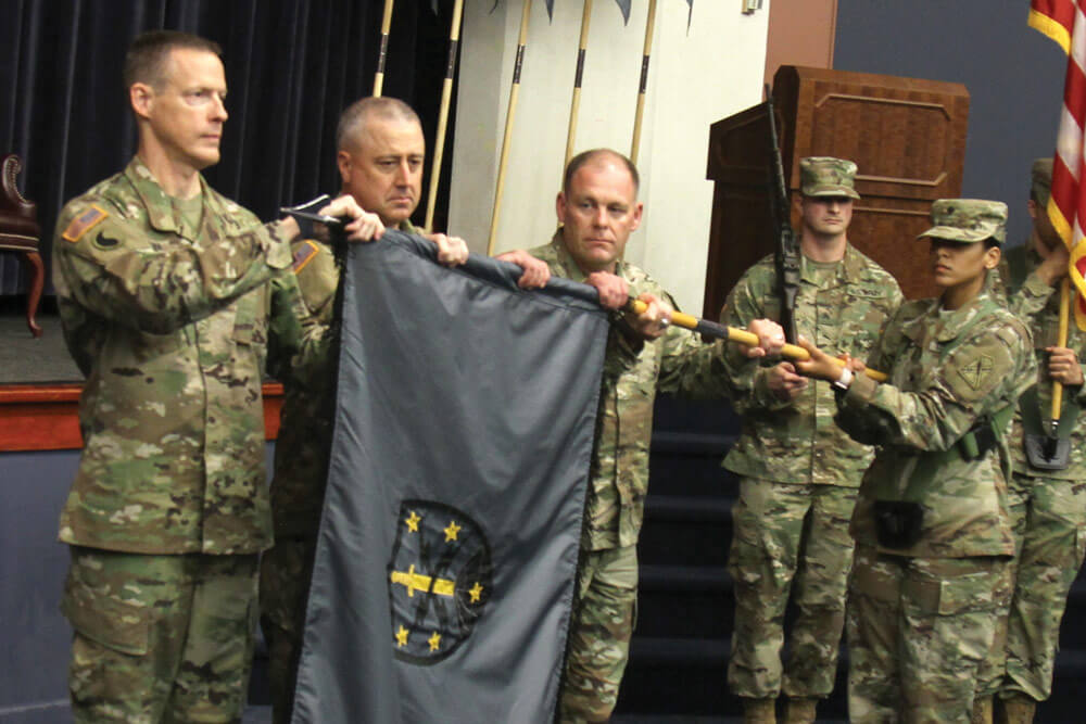 The command team for the 91st Cyber Brigade uncases their new unit colors.