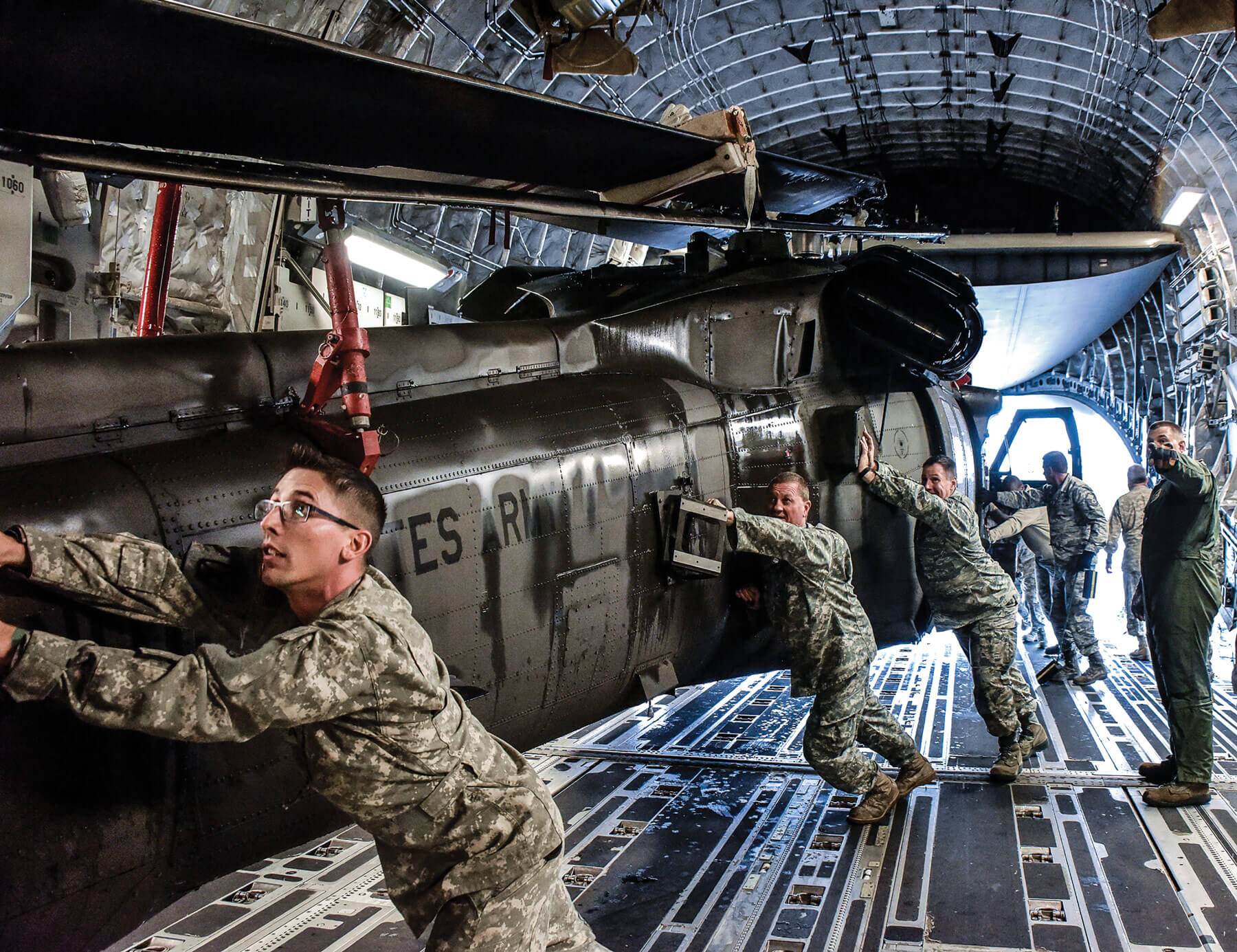 Tennessee National Guard Soldiers push a UH-60 Black Hawk into a C-17 aircraft carrier at Joint Base Berry Field, Nashville, Tenn. The Tennessee Guard deployed to the U.S. Virgin Islands to support disaster relief efforts and provide humanitarian aid in the aftermath of Hurricane Irma.