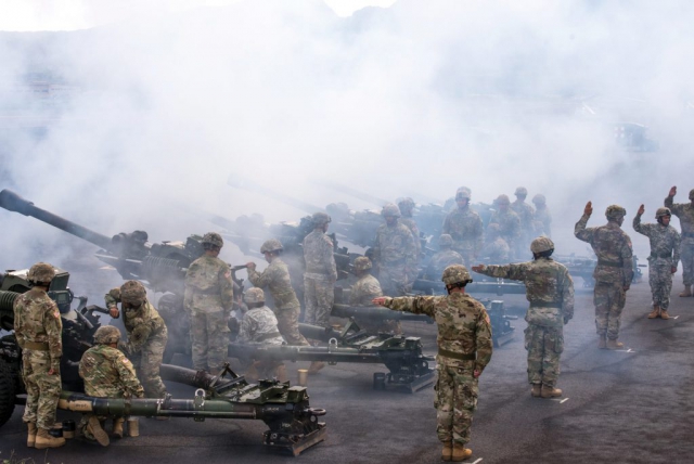 The 487th Field Artillery renders honors during the Hawaii Army National Guard Change of Command ceremony at Wheeler Army Airfield, Hawaii. All Hawaii Army National Guard units and service members were in attendance at the ceremony.