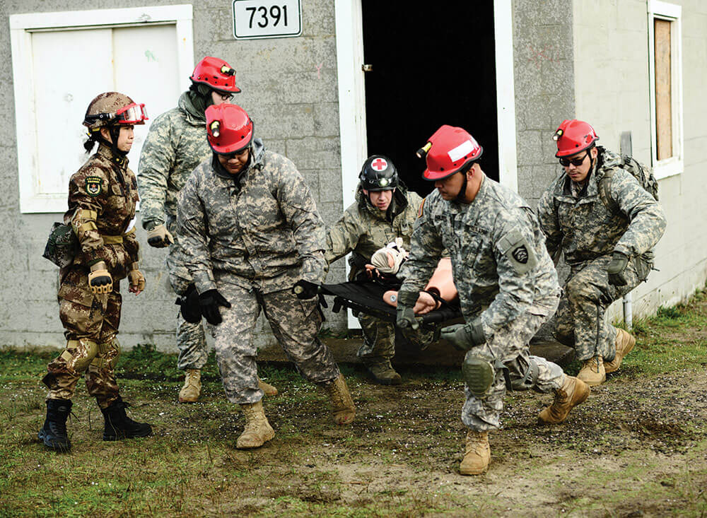 Soldiers of the Oregon Army National Guard work with soldiers of the People’s Liberation Army to assess and extract a simulated casualty. Oregon Army National Guard photo by SFC April Davis.