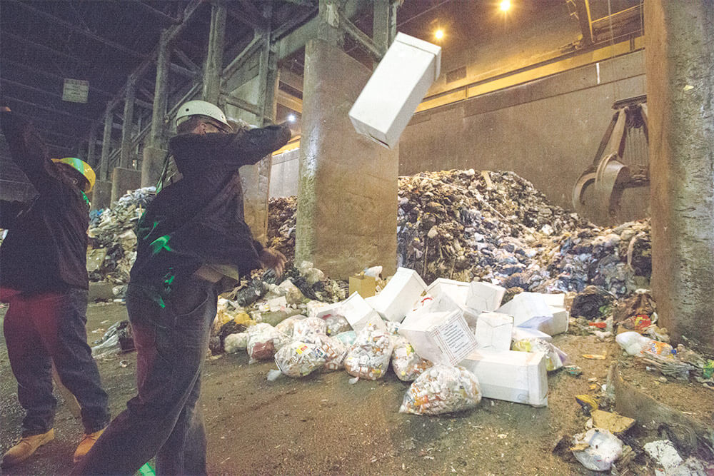 Soldiers of the New Jersey National Guard, along with agents from the Drug Enforcement Administration,` dump prescription drugs for incineration at the Covanta Essex Resource Recovery Facility. National Guard photo by MSgt Matt Hecht.