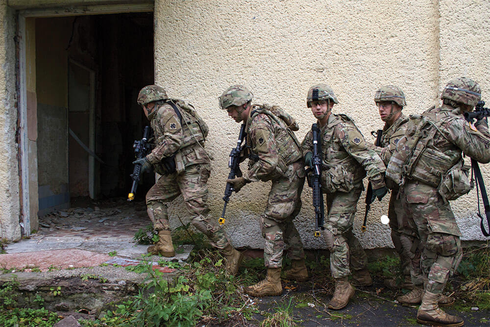 Soldiers of the 45th Infantry Brigade Combat Team stack and enter a building during the field training portion of a basic leader course at the Yavoriv Combat Training Center. Oklahoma Army National Guard photo by SGT Anthony Jones.