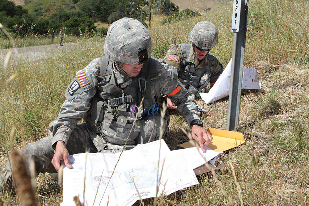 SGT Oswald Sanchez (left) and SGT Grant Reimers plot map coordinates during the land navigation phase of the Army National Guard Best Warrior Competition. Army National Guard photo by SSG Edward Siguenza.