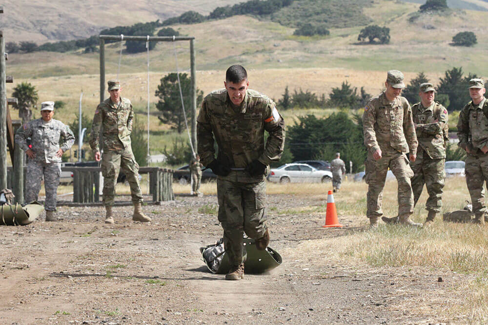 SGT Grant Reimers drags a 180-pound skid in the obstacle course event of the 2017 Army National Guard Region VII Best Warrior Competition. Army National Guard photo by SSG Edward Siguenza.