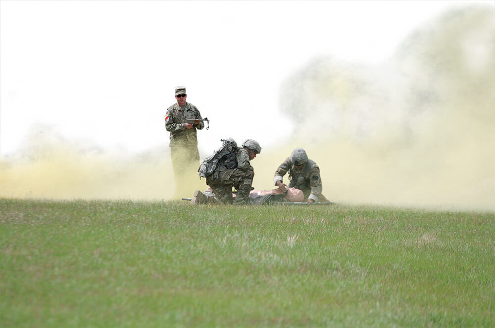 Two 1-221st Cavalry scouts simulate first aid on a training dummy during the medical lane event of the 2017 Gainey Cup. Nevada Army National Guard photo by SGT Walter H. Lowell.