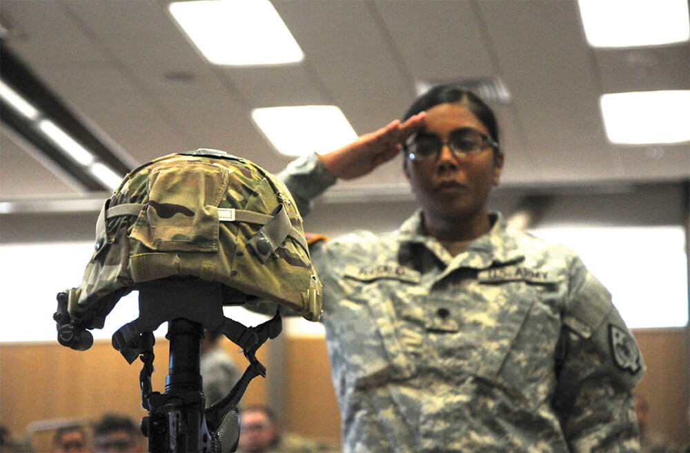 A Soldier pays her final respects to 1SG Charleston Hartfield after his memorial service held at the North Las Vegas Readiness Center on Oct. 21, 2017. Nevada Army National Guard photo by SSG Victor Joecks.