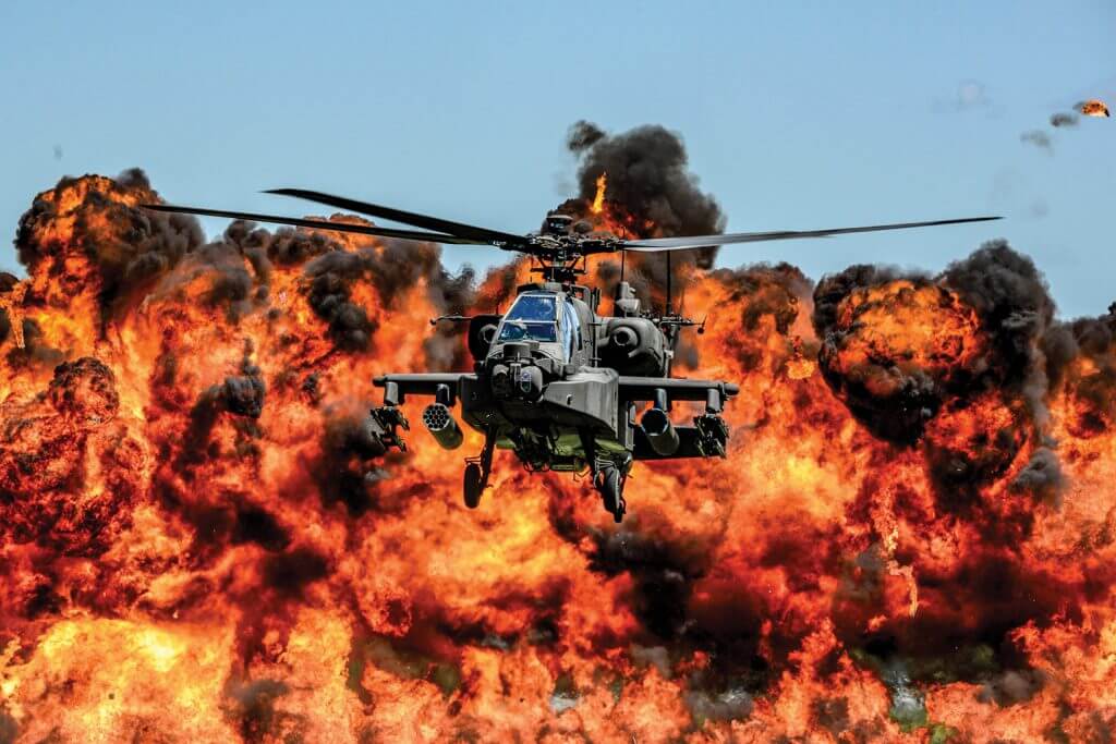An AH-64D Apache Attack Helicopter, assigned to the 1-151st Attack Reconnaissance Battalion, flies in front of a wall of fire during the South Carolina National Guard Air and Ground Expo at McEntire Joint National Guard Base, S.C., May 6, 2017. The expo is a combined arms demonstration that showcases the abilities of South Carolina National Guard members. It also offers opportunities for the South Carolina Guard to express its thanks for the support shown by fellow South Carolinians in the surrounding community. South Carolina National Guard photo by Tech Sgt Jorge Intriago