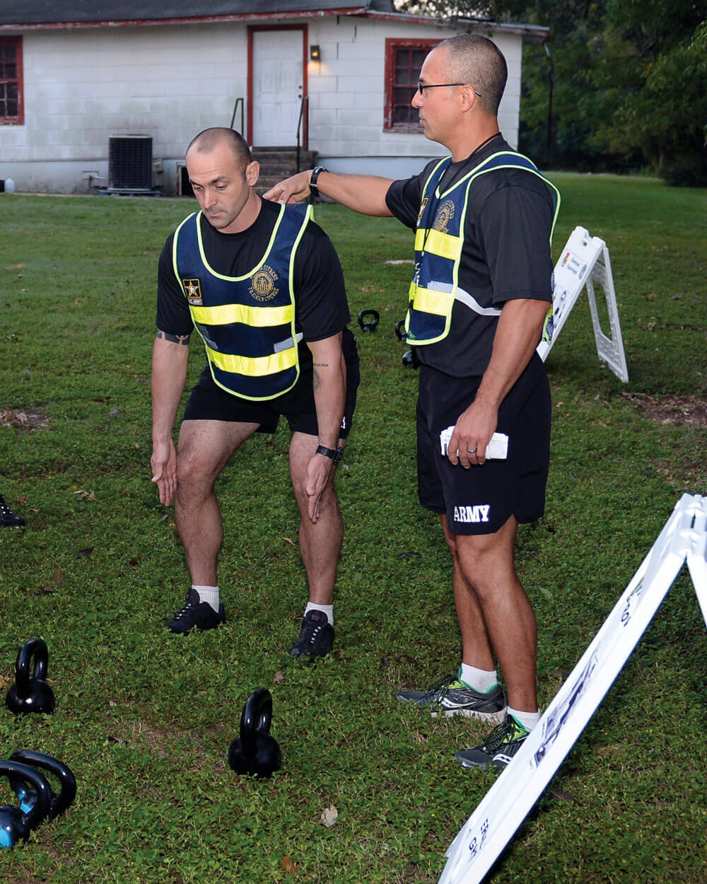 SSG Anthony Delagarza and SFC Athan Schindler, both Master Fitness Trainer Course instructors, Texas Army National Guard, demonstrate proper form during a round of circuit exercises at Camp Mabry as part of the Master Fitness Trainer Course.