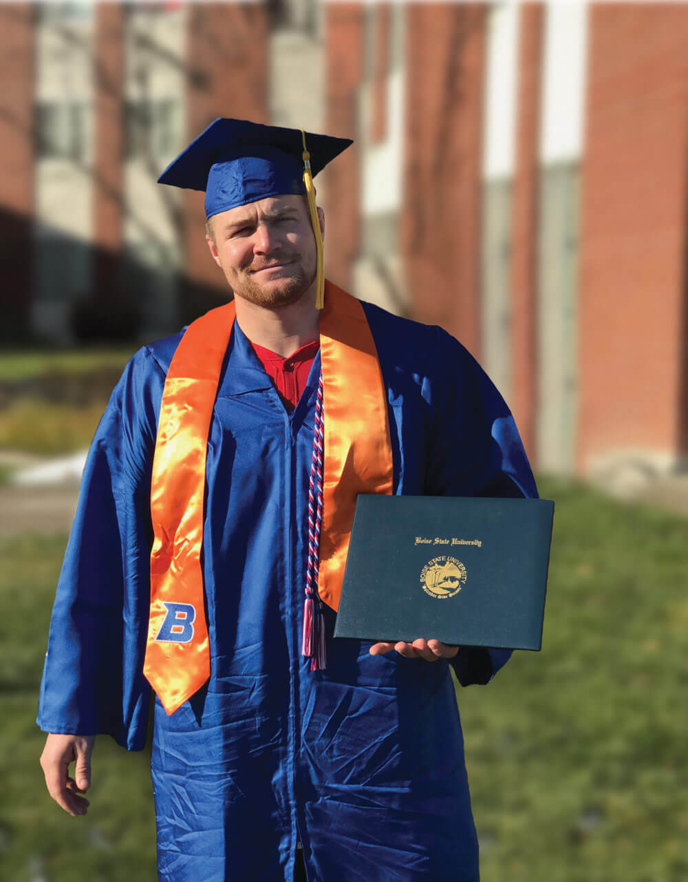 SGT Seth Gaskins displays his diploma after graduating from Boise State University. Photo courtesy SGT Seth Gaskins