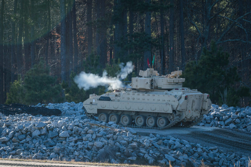 Soldiers of the 4th Squadron, 278th Armored Cavalry Regiment, fire from a Bradley during the final weekend of the regiment’s qualification training held at Fort Pickett.