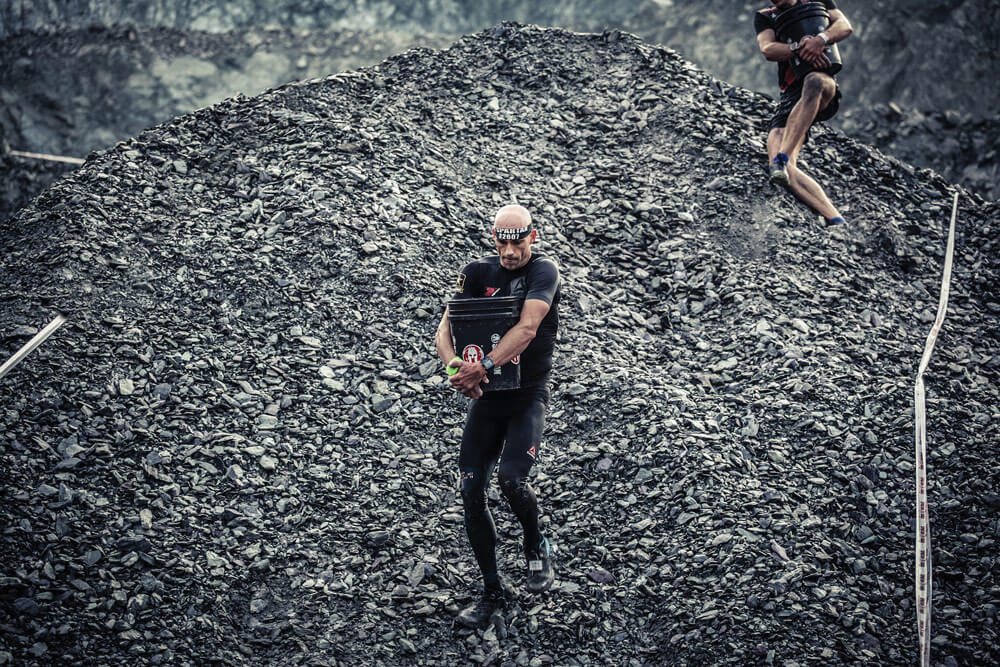 As part of the 2017 Oberndorf/Tirol Spartan Beast race held in Oberndorf, Austria, CPT Robert Killian races down a man-made hill during the Bucket Carry segment of the race.