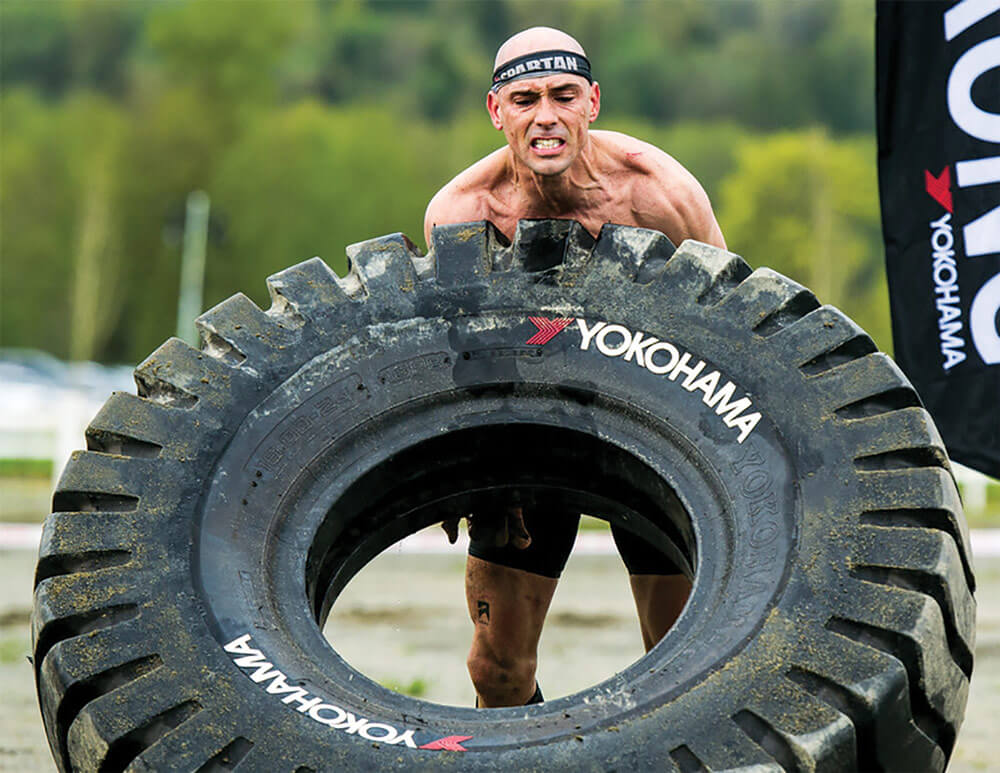 CPT Robert Killian digs deep to flip a giant tire during the Yokohama Tire Flip segment of the 2017 Seattle Super and Sprint Spartan Race.