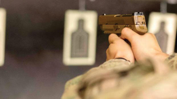 A Soldier fires the new M17 or Modular Handgun System at the 5th Special Forces Group (Airborne) indoor range. U.S. Army photo by SGT Samantha Stoffregen