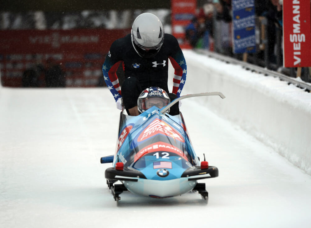 SGT Nick Cunningham (front) and teammate SGT Dallas Robinson slide to second place in the two-man event at the International Bobsled & Skeleton Federation’s 2013 World Cup stop. U.S. Army photo by Tim Hipps