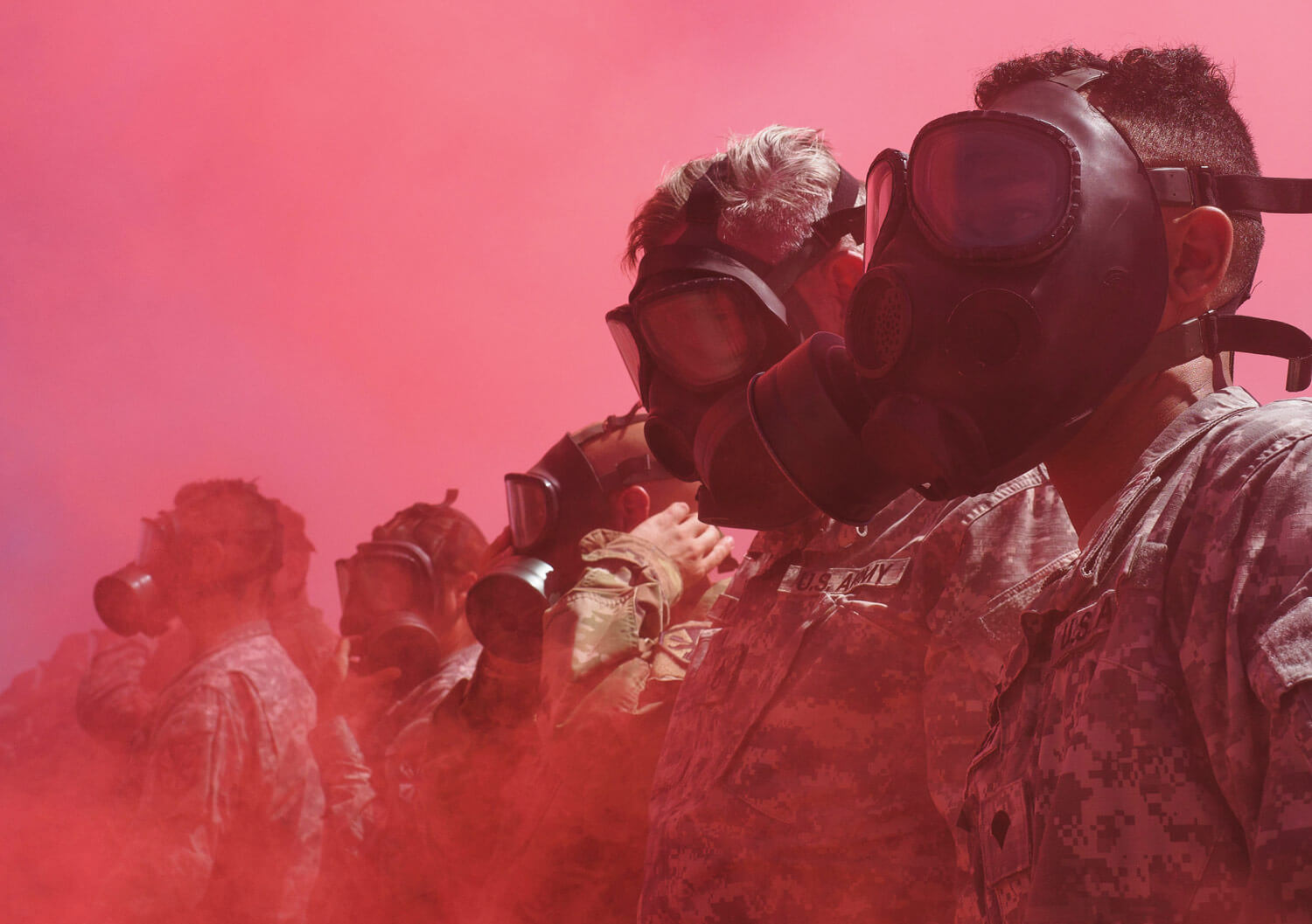 Arizona Army National Guard Soldiers from the 2220th Transportation Company are engulfed by colored smoke after putting on their protective masks during a simulated chemical attack at Florence Military Reservation in Florence, Ariz. Arizona Army National Guard photo by SSG Brian A. Barbour
