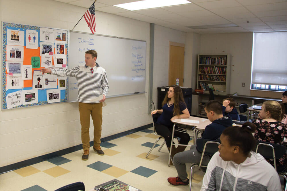 2LT Gregory Kessler conducts a lesson on essay writing as his language arts students at Horace Mann Middle School listen attentively. Massachusetts Army National Guard photo by SPC Samuel D. Keenan