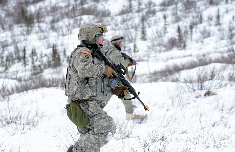 National Guard Soldiers make their way through snowcovered, mountainous terrain during a dry fire exercise while participating in Arctic Eagle 2018.