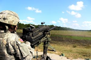 A Soldier fires a .50 cal Machine Gun and MK19 Grenade Launcher. U.S. Army photo by Erich Backes