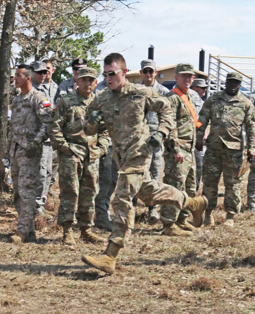 Texas Army National Guard SGT Peter Scharff completes the final stretch of the obstacle course during the Texas Military Department Best Warrior Competition at Camp Swift, Texas, March 1, 2018. Texas Army National Guard photo by SGT Mark Decker