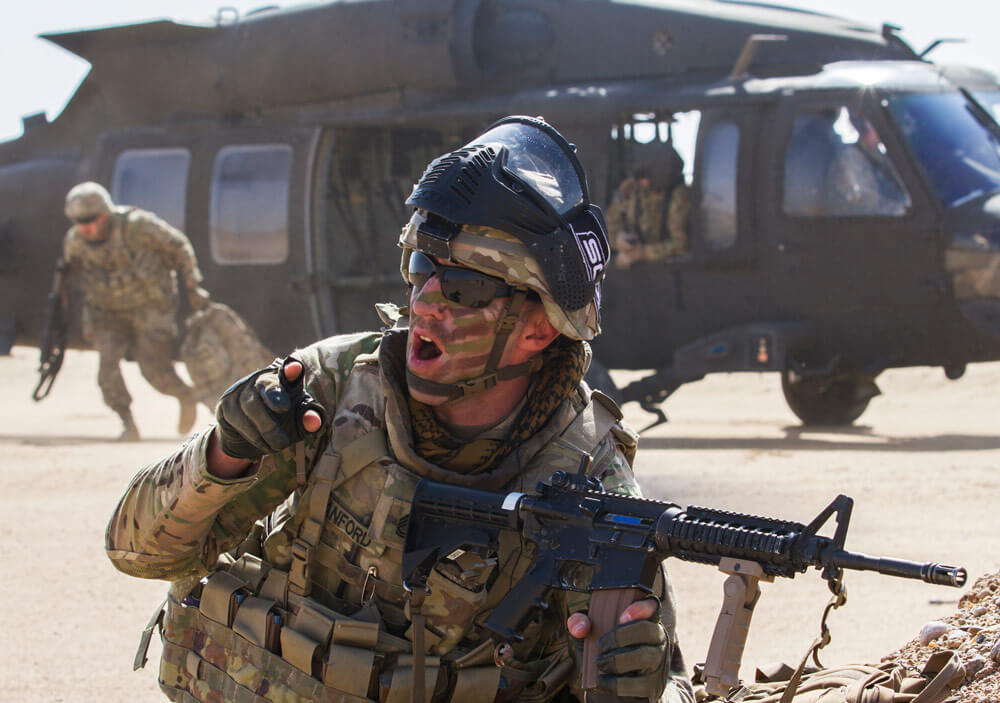 SFC Aaron Sanford, maintenance supervisor with Delta Battery, 1st Battalion, 145th Field Artillery Regiment, Utah Army National Guard, shouts commands to his platoon after landing in a UH-60 Black Hawk near Camp Buehring, Kuwait, Feb. 28, 2018. U.S. Army photo by SPC Joshua P. Morris