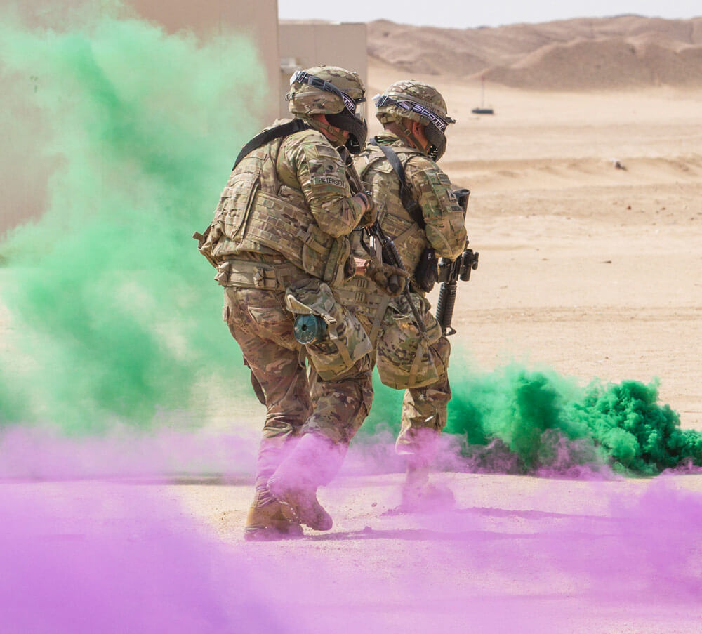 Artillerymen of Delta Battery, 1st Battalion, 145th Field Artillery Regiment, Utah Army National Guard, charge towards a village after deploying smoke grenades during a training exercise near Camp Buehring, Kuwait, Feb. 28, 2018. U.S. Army photo by SPC Joshua P. Morris