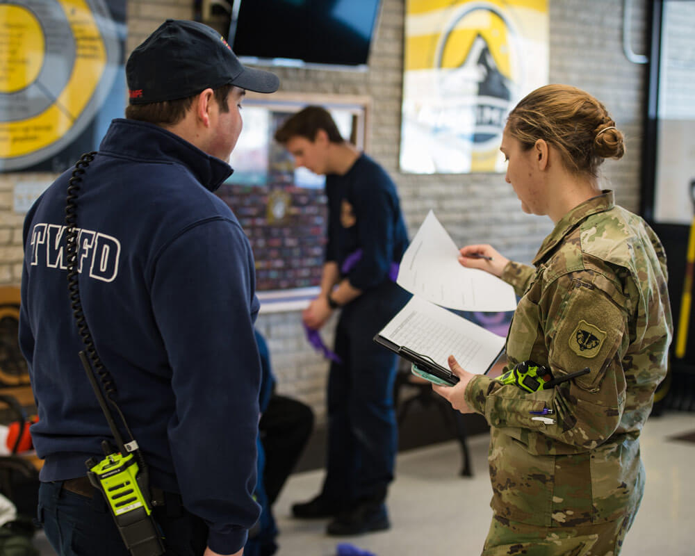 Cadet Lauren Niemiec works with a local Waukesha EMT to triage patients, transporting them from the point of injury to higher levels of care during a medical training exercise in Waukesha, Wis. Wisconsin Army National Guard photo by SSG Alex Baum