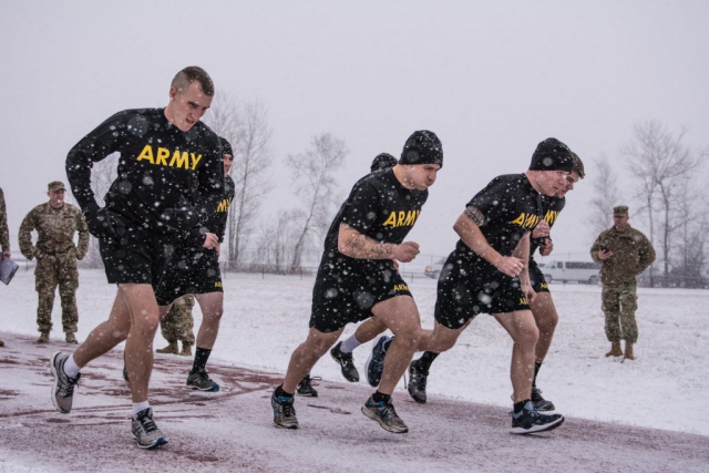 Soldiers from the Maine Army National Guard plow through the snow during the Army Physical Fitness Test at the Armed Forces Reserve Center track in Bangor, April 6, 2018. These Soldiers are competing in the State level of the Best Warrior Competition. Competitors are handpicked as the best representatives the State has to offer from over 2000 members of the Maine Army National Guard. Maine Army National Guard photo by SPC Jarod Dye