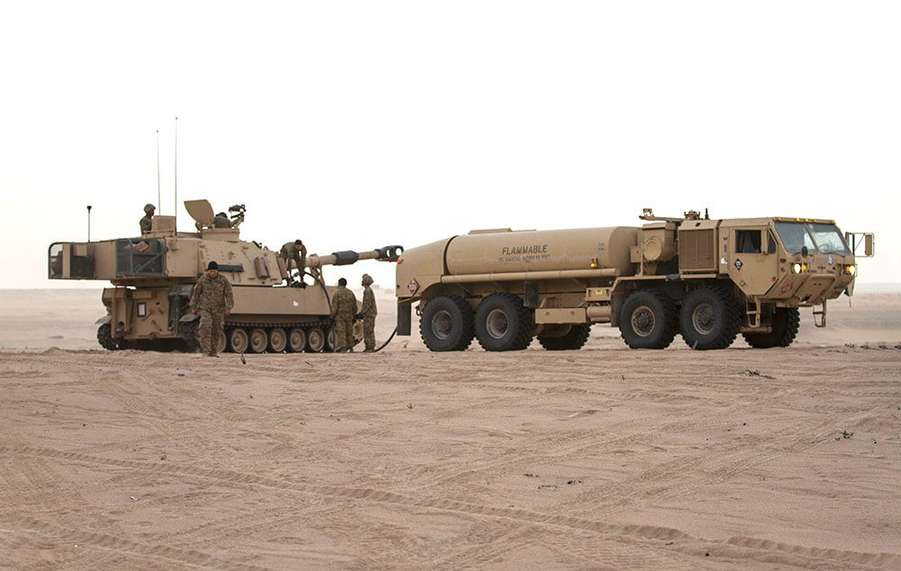 Soldiers from the Texas Army National Guard refuel an M109 Paladin during Iron Union 18-6 in the United Arab Emirates, where the 35th Infantry Division served as division command. U.S. Army photo by SGT Thomas X. Crough