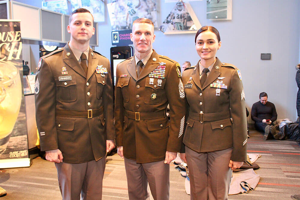 Sergeant Major of the Army SGM Daniel Dailey (center) and Soldier models SSG Aaron Johnson (left) and SGT April Schacher (right) showcase the newly proposed Pinks & Greens daily service uniform at the 2017 Army-Navy game in Philadelphia, Pa. U.S. Army photo by Ron Lee