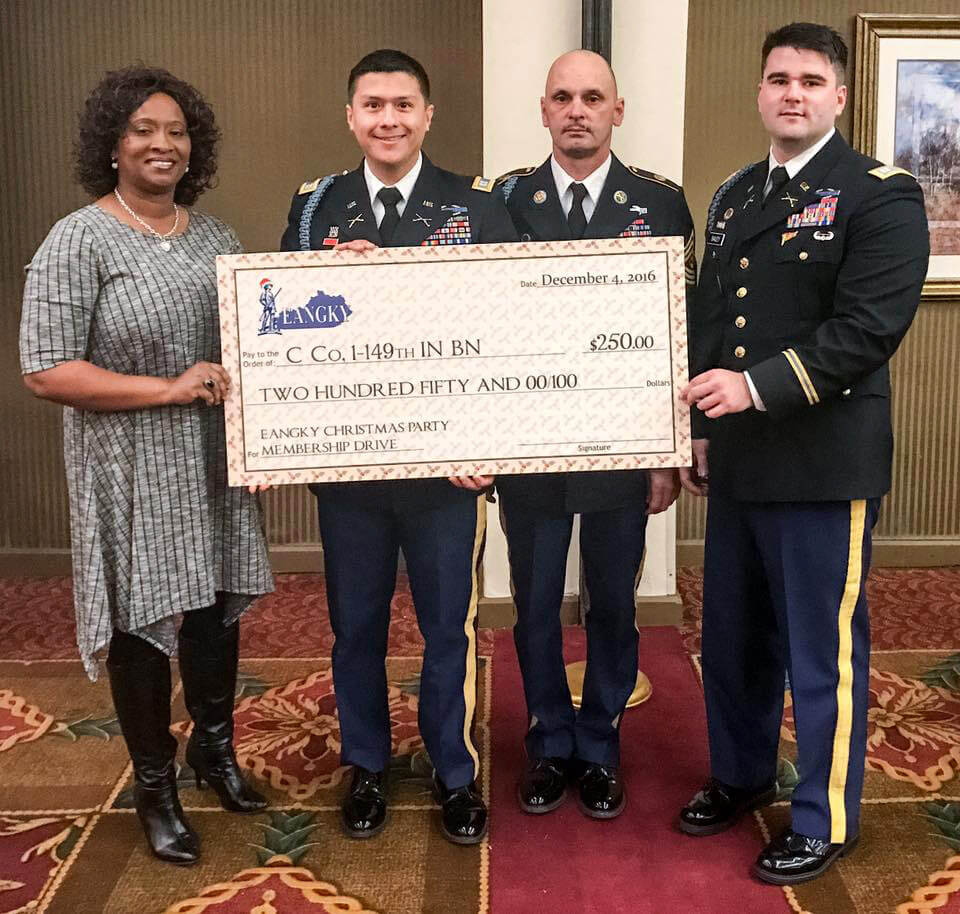 LEFT: Shelia Brookins, as EANGKY Auxiliary President, presents a check to Soldiers of C Company, 1st Battalion, 149th Infantry Regiment, Kentucky Army National Guard, who are accepting the check on behalf of their company as the winners of EANGKY’s Second Annual Membership Drive Contest, Dec. 7, 2016. Photos courtesy Enlisted Association of the National Guard of Kentucky