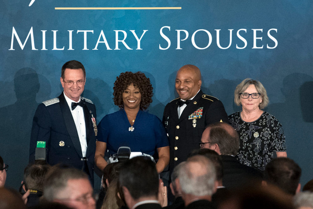 Shelia Brookins (2nd from left) poses for photos with Air Force Gen Joseph Lengyel (far left), chief of the National Guard Bureau, her husband SFC Darrell Brookins, and Sally Lengyel, wife of Gen Lengyel, at the USO of Metropolitan Washington-Baltimore’s 36th Annual Awards Dinner in Washington, D.C., where she accepted the 2018 Armed Forces Insurance National Guard Spouse of the Year Award, May 10, 2018. DoD photo by EJ Hersom