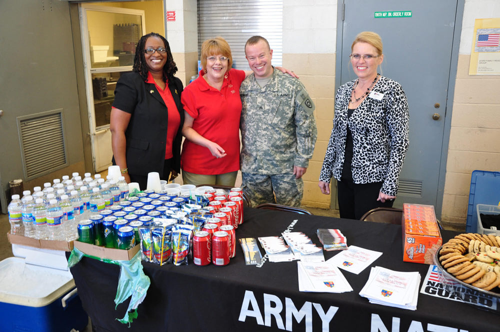 Shelia Brookins (left), Libby Cox (center left) and Nancy Brewer work with a Soldier of the Kentucky Army National Guard handing out refreshments and Family Support Information at the Beuchel Armory, Louisville, Kentucky National Guard Center on Nov. 2, 2011. Kentucky National Guard Yellow Ribbon Program photo by 1LT Mark Slaughter