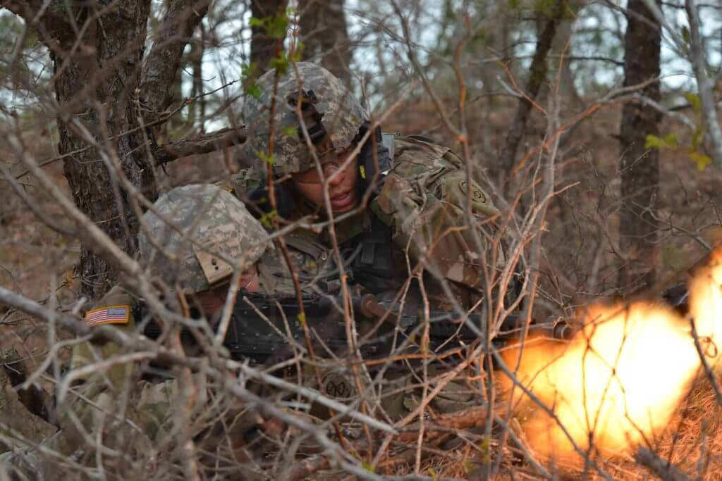 Soldiers from the 182nd Infantry Regiment, Massachusetts National Guard use scrub brush for concealment as they fire an M240 machine gun at a notional enemy during a training exercise at Joint Base Cape Cod, May 5, 2018. Over the course of four days, the Massachusetts Guard Soldiers conducted air assault raids using aviation assets provided by the New York National Guard. Massachusetts Army National Guard photo by SPC Samuel D. Keenan