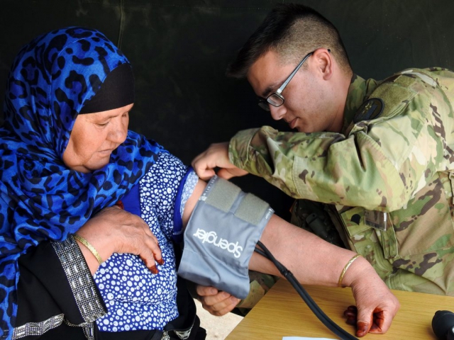 SPC Nathan Ro of the Utah Army National Guard’s Medical Command checks the blood pressure of a Moroccan citizen during Exercise African Lion 2018, April 15–April 28. The overseas deployment training was a joint initiative between the armed forces of the United States, Morocco, Tunisia, Canada and six European nations. The annually scheduled exercise involves various types of training and maneuvers held throughout Morocco. The Utah Army National Guard was responsible for the exercise’s Humanitarian and Civic Assistance event. Utah Army National Guard photo by MAJ Samantha Madsen