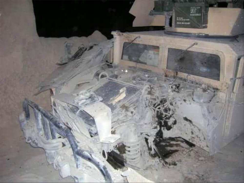 Image of the High Mobility Multipurpose Wheeled Vehicle (HMMWV), on which SPC Cole LaRocque was the gunner, after it was destroyed by an improvised explosive device (IED) in Afghanistan, 2006. Photo courtesy SPC Cole LaRocque