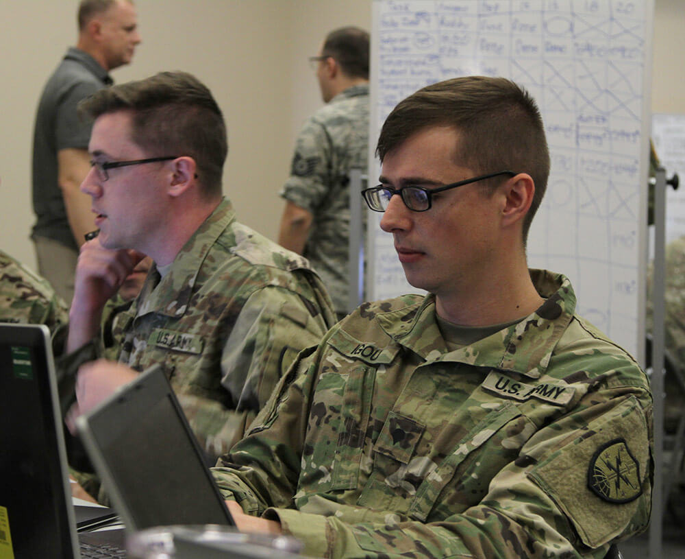 SPC David Igou, an information technology specialist for the 144th Cyber Warfare Company, works to infiltrate and disrupt networks run by notional enemies during a training scenario as part of Cyber Shield 18 at Camp Atterbury, Ind. Ohio Army National Guard photo by SSG Chad Menegay