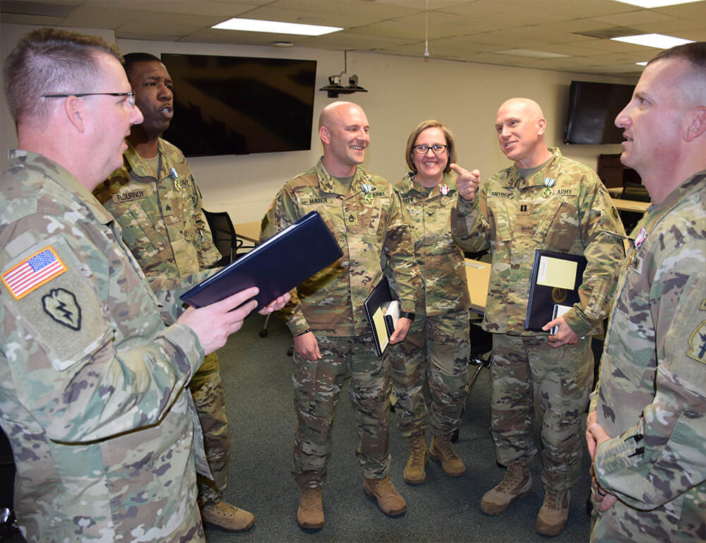 FROM LEFT: Colorado National Guard Chief of the Joint Staff COL Scott M. Sherman talks with SGT Kordney Flournoy, SFC Seth Mager, COL Kelsey Marchalk, CPT Scott Snyder and SFC Stephen Russ, all members of the Colorado Army National Guard Mobile Training Team recognized for accomplishments in working with the Jordan Analytical Laboratory System. Colorado Army National Guard photo by SSG Joseph K. VonNida