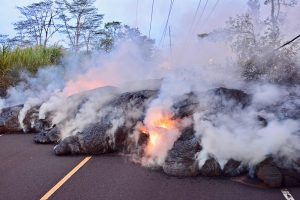 Burning lava flows onto a residential street in the Puna district of Hawaii, May 28, 2018. Hawaii National Guard photo by MSgt Thomas Wheeler