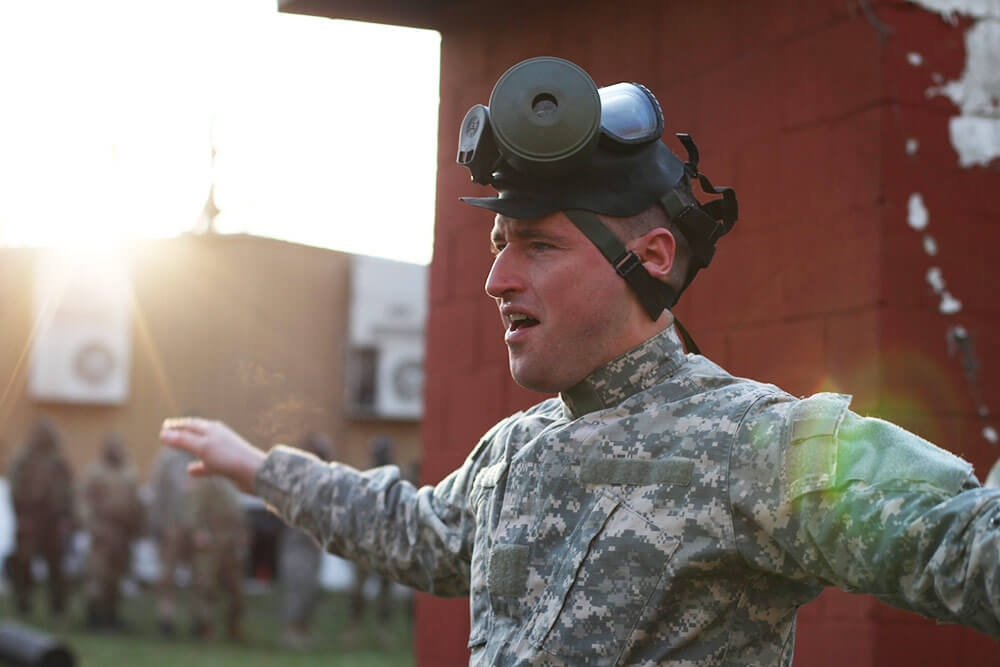 An Indiana Army National Guard Soldier flaps his arms in an attempt to clear away remaining tear gas after exiting a gas chamber during chemical, biological, radiological and nuclear defense response training held at Camp Atterbury Maneuver Training Center, Ind. Indiana Army National Guard photo by SGT Alejandro Smith-Antuna